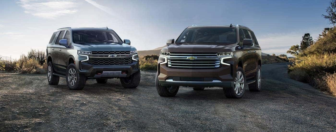Two 2021 Chevy SUVs, a Tahoe and Suburban, parked side by side