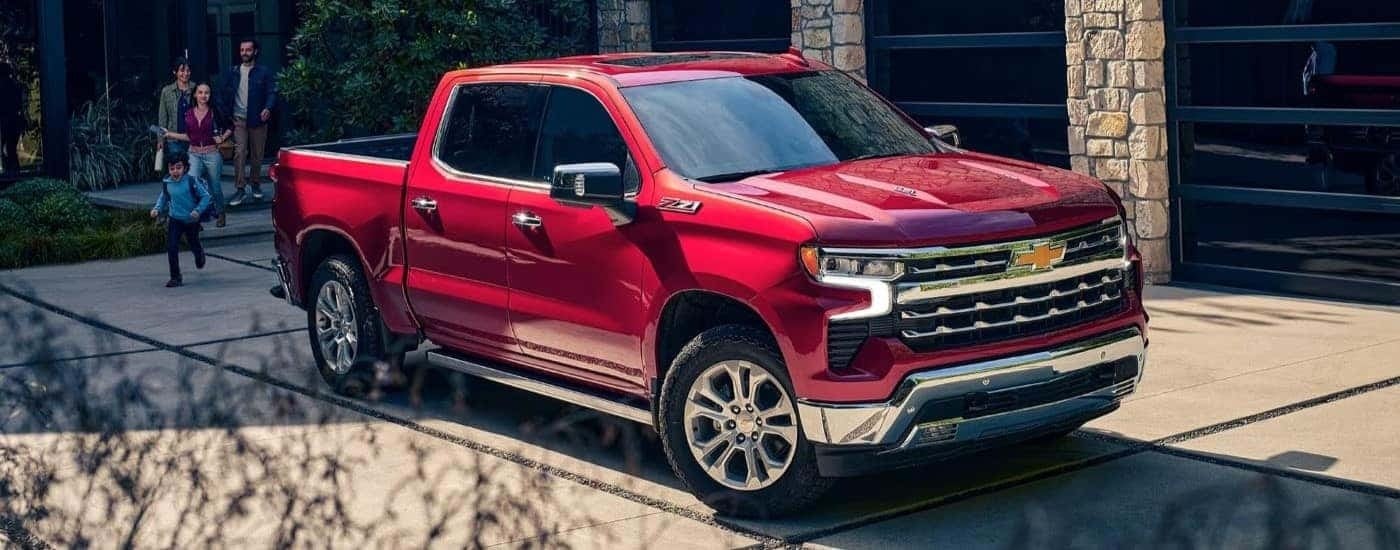 A red 2023 Chevy Silverado 1500 Z71 is shown parked in a driveway
