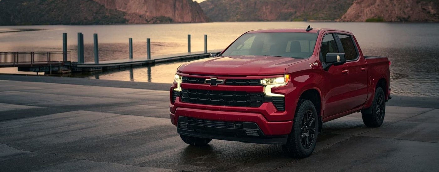 A red 2024 Chevy Silverado 1500 RST is shown parked near a lake after viewing a Chevy Silverado 1500 near Vestavia Hills.
