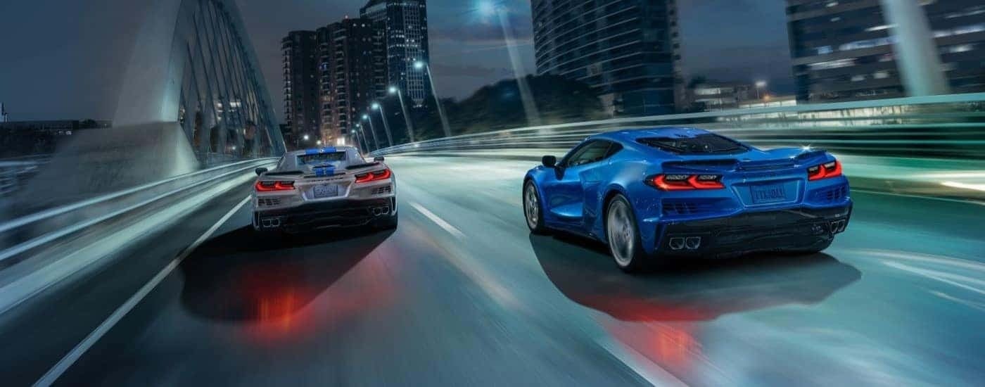 Two 2024 Chevy Corvette E-Reay driving over a bridge to look at cars for sale