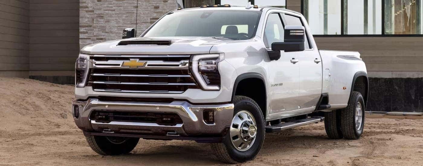 A white 2025 Chevy Silverado 3500 HD parked on a construction site.