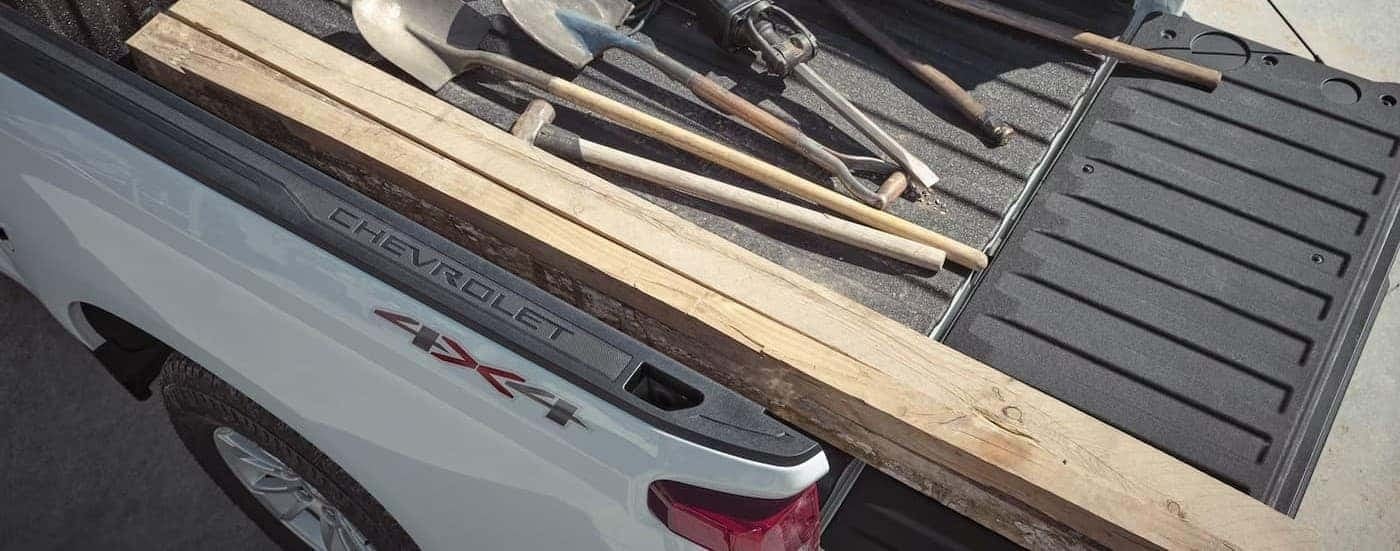 Tools in the bed of a white 2026 Chevy Silverado 1500.