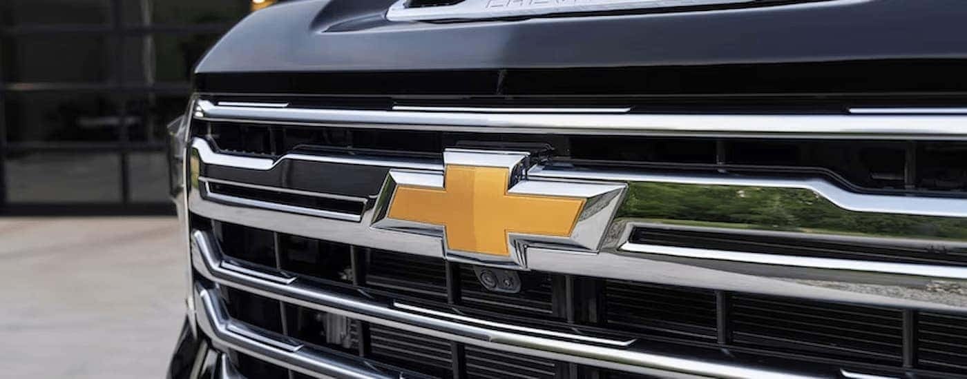 Grille and badge of a black 2026 Chevy Silverado 2500HD