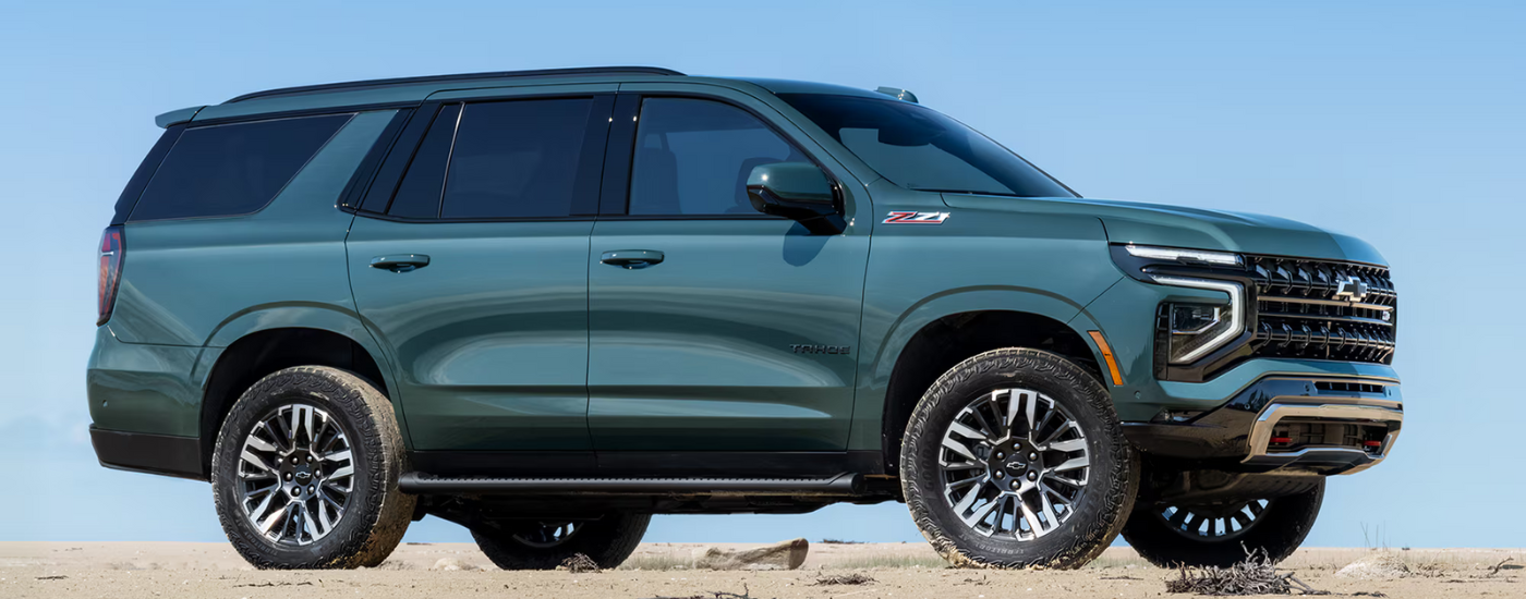 A green 2025 Chevy Tahoe Z71 is parked on sand