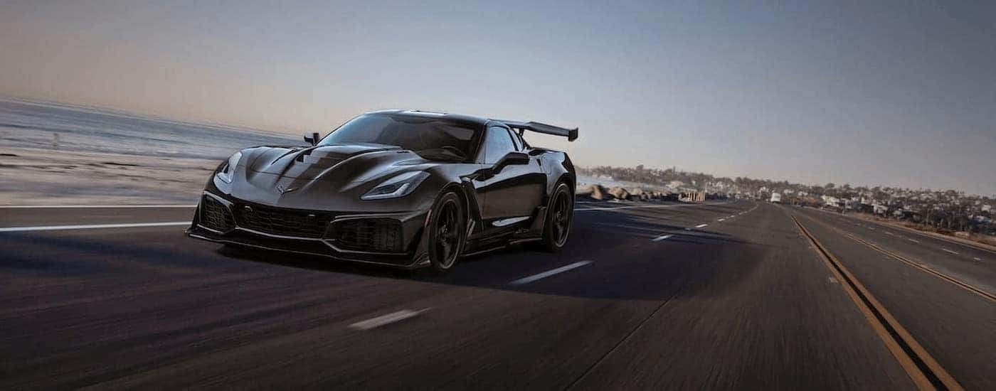 A black 2019 Chevy Corvette C7 ZR1 is driving on an open road