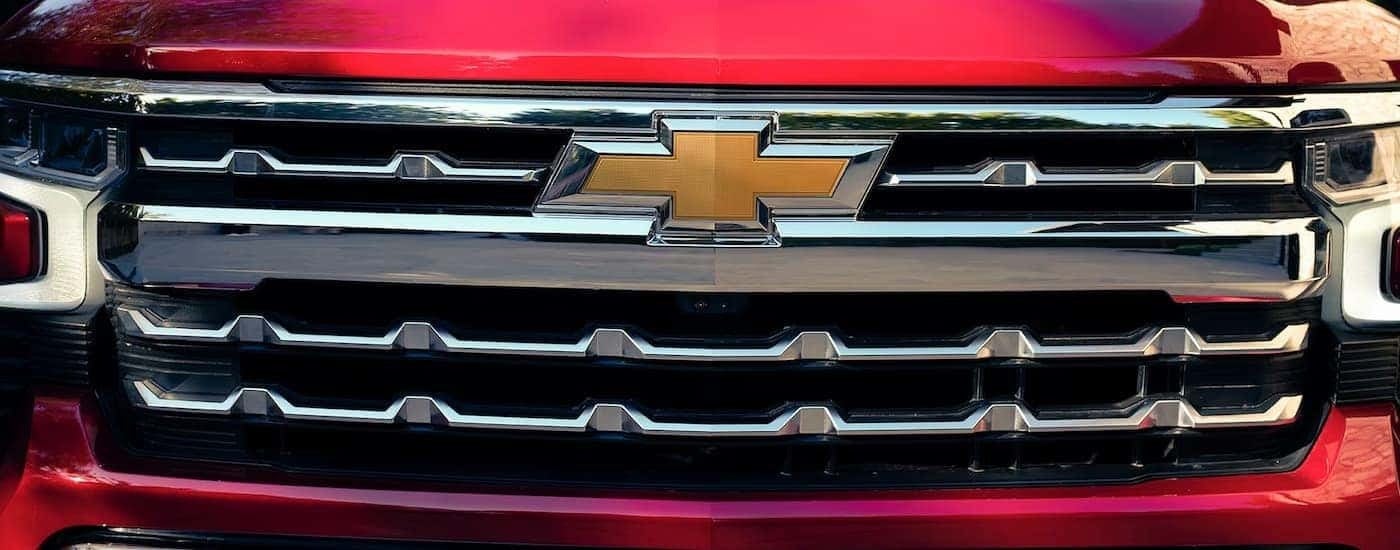 A close up of the grille on a red 2023 Chevy Silverado 1500 LTZ.