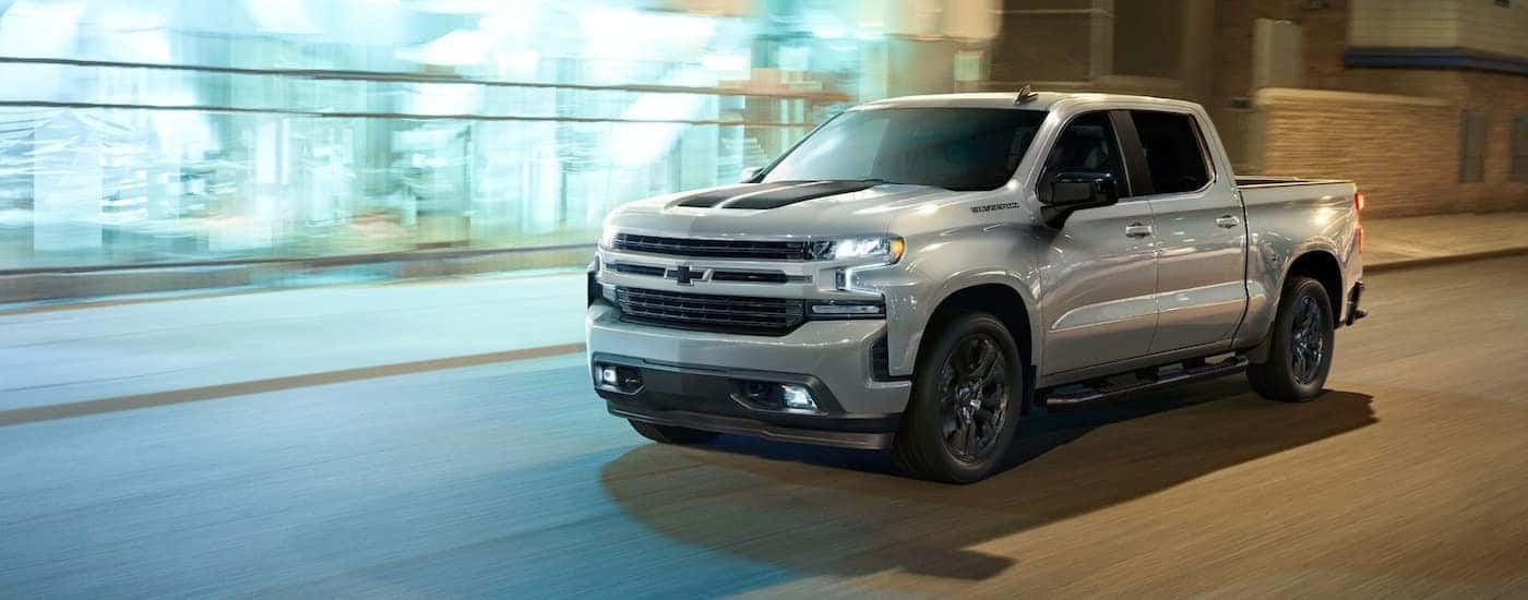 Silver 2020 Chevy Silverado 1500 RST Rally driving to see a Chevy Silverado for sale near Vestavia Hills