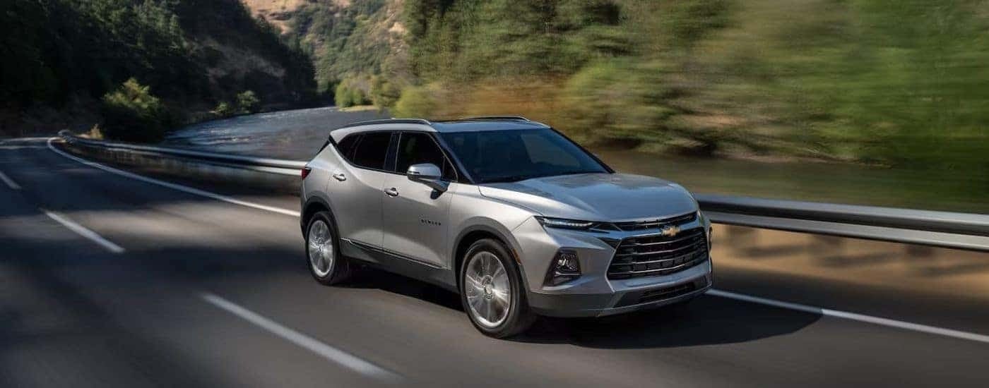 A silver 2022 Chevy Blazer Premier is shown driving on a mountain highway after leaving a Vestavia Hills Chevy dealer.